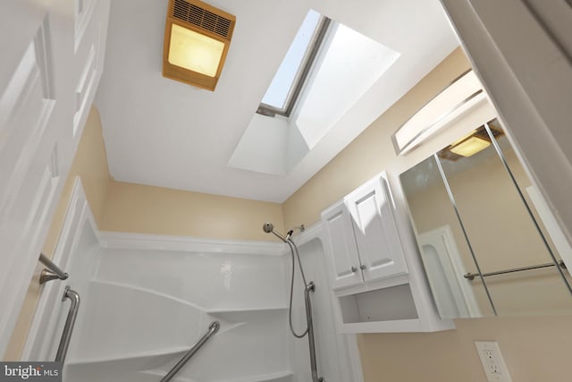 bathroom with shower with separate bathtub and a skylight