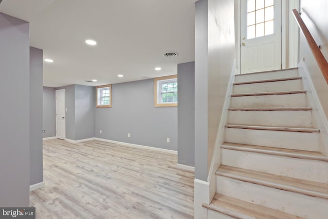 stairs featuring hardwood / wood-style floors