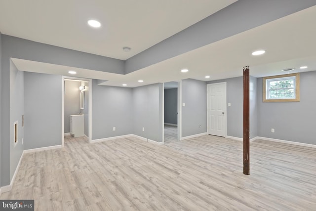 basement with light hardwood / wood-style flooring