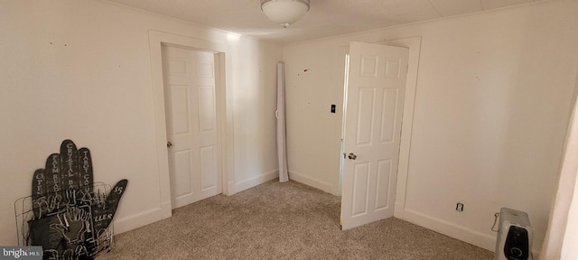 spare room featuring light colored carpet