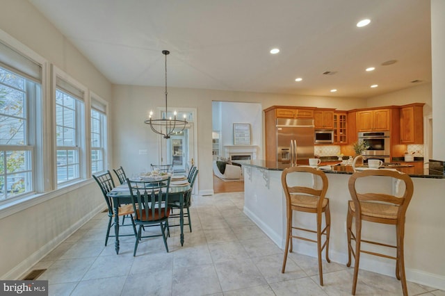 17061 Spring Creek Ln, Leesburg, VA 20176 - dining room featuring a chandelier, recessed lighting, baseboards, and a fireplace