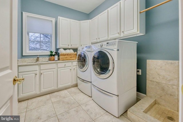 17061 Spring Creek Ln, Leesburg, VA 20176 - laundry room with cabinet space, washer and dryer, and light tile patterned floors