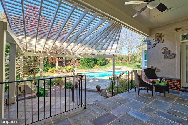 view of patio / terrace with a fenced in pool, a pergola, and ceiling fan