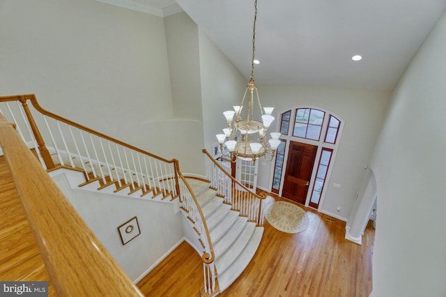 17061 Spring Creek Ln, Leesburg, VA 20176 - entrance foyer with a chandelier, wood finished floors, stairway, baseboards, and high vaulted ceiling