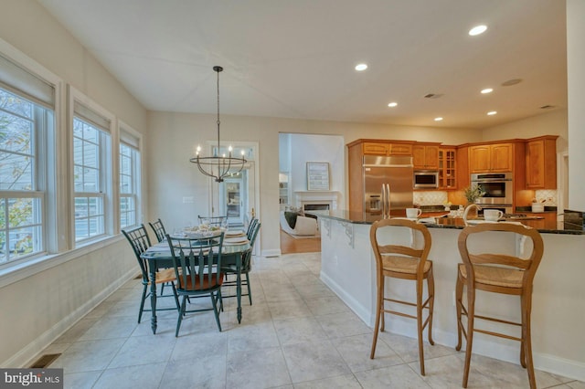 tiled dining area featuring a notable chandelier