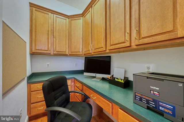 office space with built in desk and hardwood / wood-style flooring