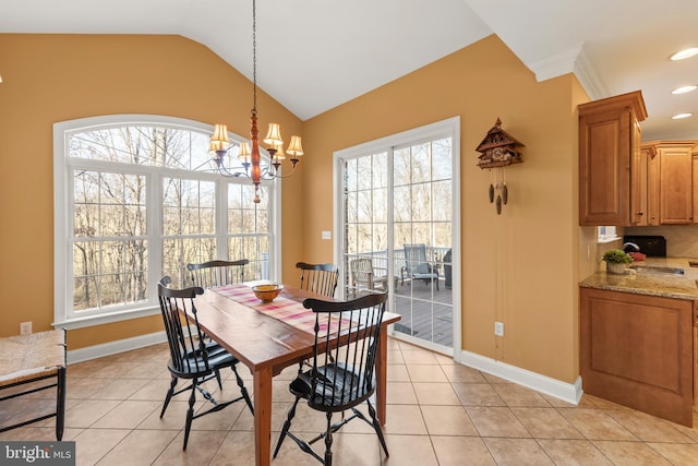 dining room featuring light tile patterned flooring, vaulted ceiling, crown molding, and an inviting chandelier