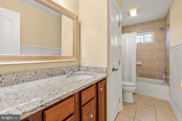 full bathroom with tile patterned floors, shower / tub combo with curtain, vanity, and toilet