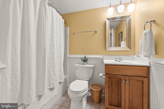 full bathroom featuring shower / bath combo with shower curtain, tile patterned flooring, vanity, and toilet