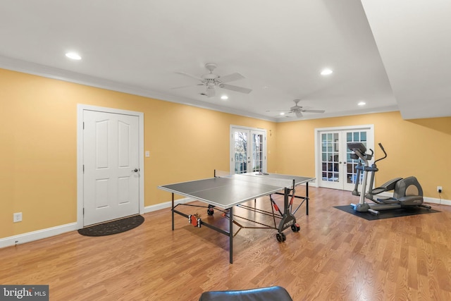 playroom featuring french doors, light hardwood / wood-style flooring, ceiling fan, and crown molding