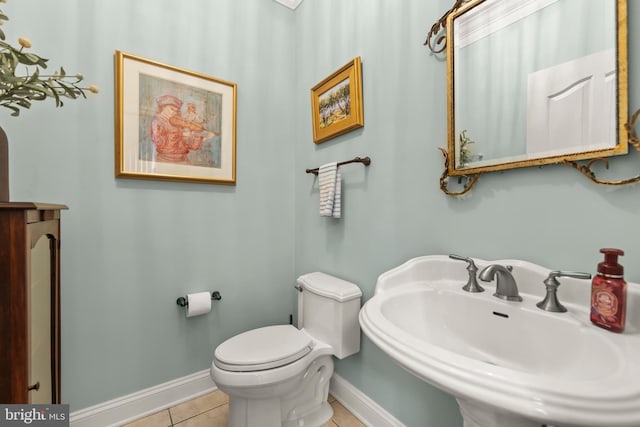 bathroom with tile patterned flooring, toilet, and sink