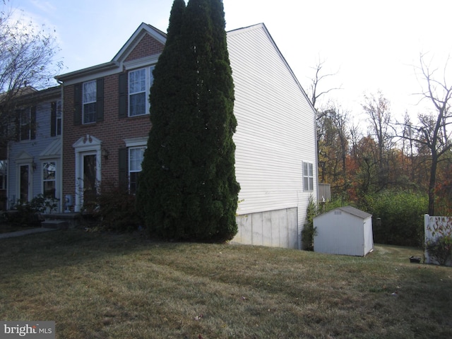 view of home's exterior with a yard and a shed