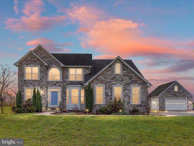 front facade featuring a lawn and a garage