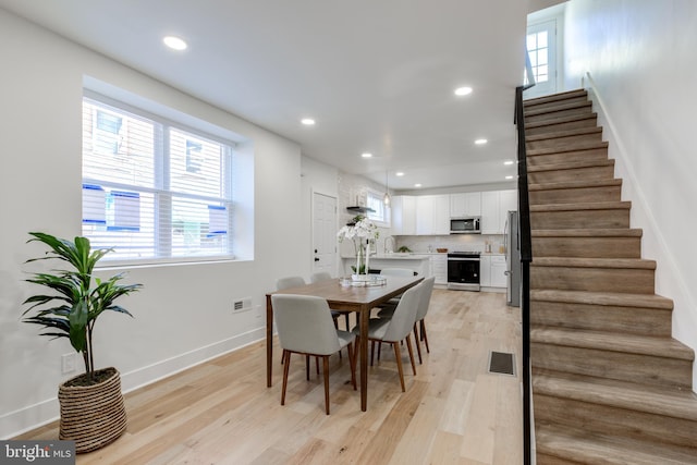 dining area featuring light wood-type flooring