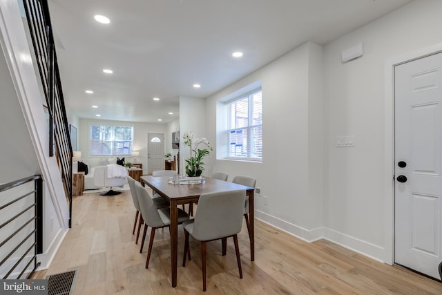 dining area featuring plenty of natural light and light hardwood / wood-style flooring