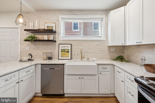 kitchen with white cabinets, pendant lighting, and appliances with stainless steel finishes