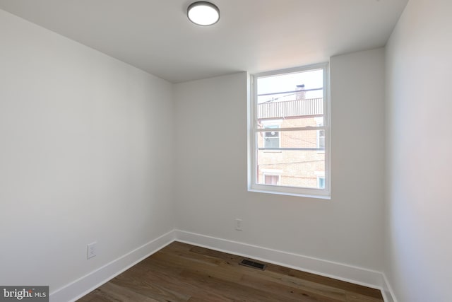 empty room with dark hardwood / wood-style floors