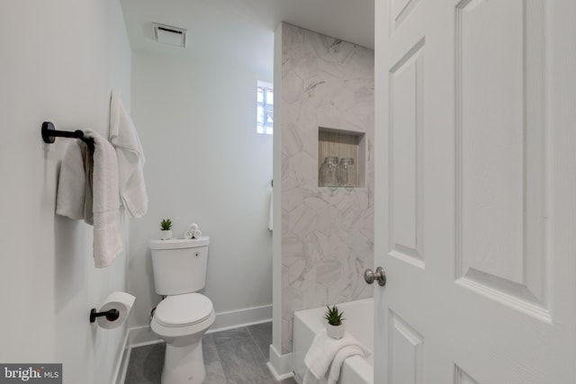 bathroom with toilet and a tub to relax in