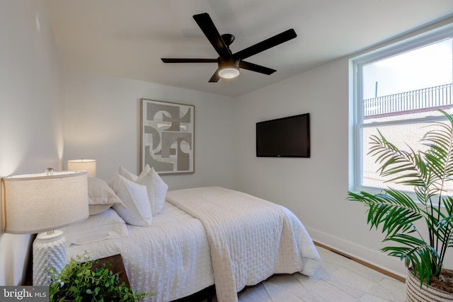 bedroom with ceiling fan and light hardwood / wood-style flooring