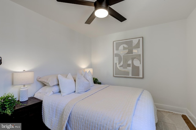 bedroom featuring light carpet and ceiling fan