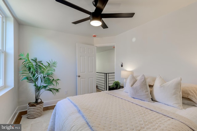 bedroom with light hardwood / wood-style floors and ceiling fan