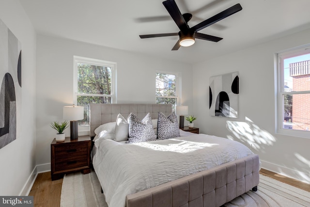 bedroom featuring light wood-type flooring and ceiling fan