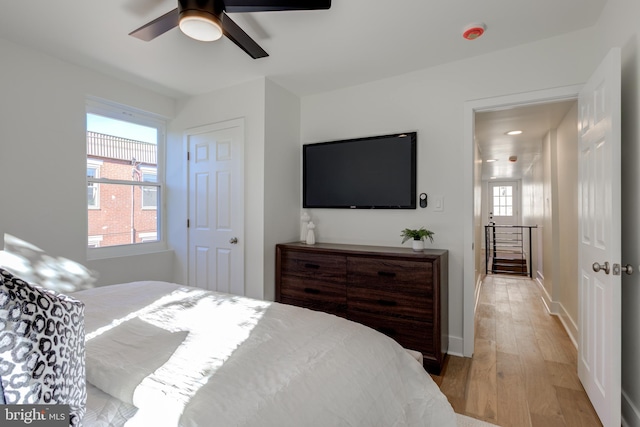 bedroom with ceiling fan and light hardwood / wood-style floors