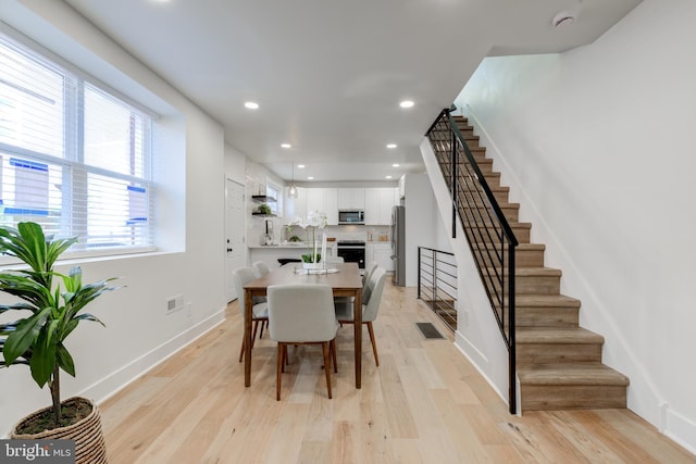 dining space featuring light hardwood / wood-style floors