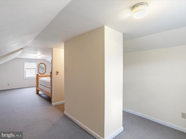 bonus room featuring carpet flooring and vaulted ceiling