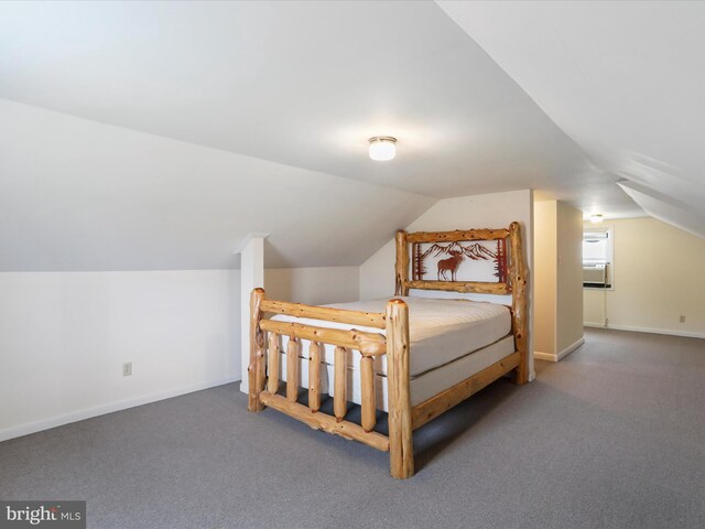 bedroom with dark carpet and lofted ceiling