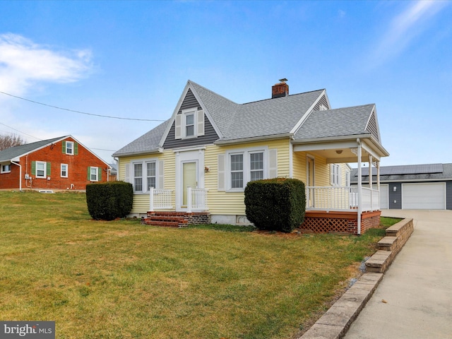 view of front facade with a front lawn, covered porch, and a garage