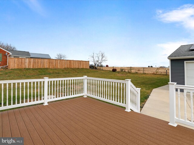 wooden terrace featuring a yard