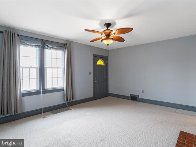 spare room with light carpet and ceiling fan