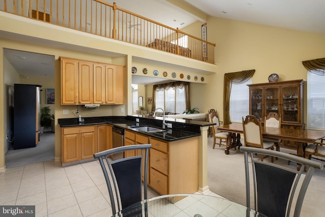 kitchen featuring sink, dishwasher, high vaulted ceiling, light colored carpet, and kitchen peninsula