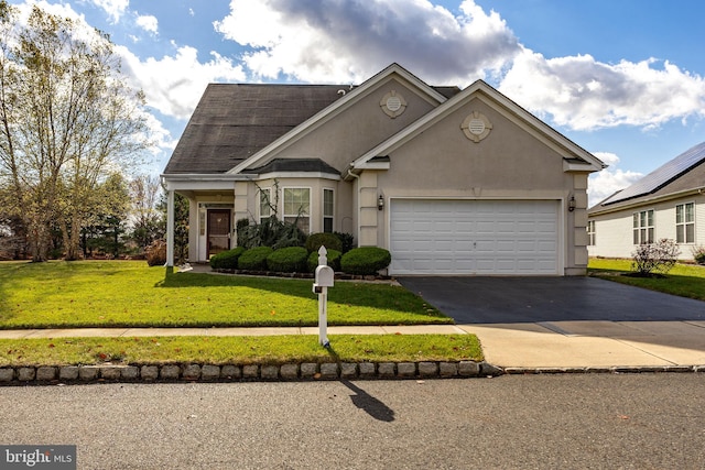 view of front facade with a garage and a front yard