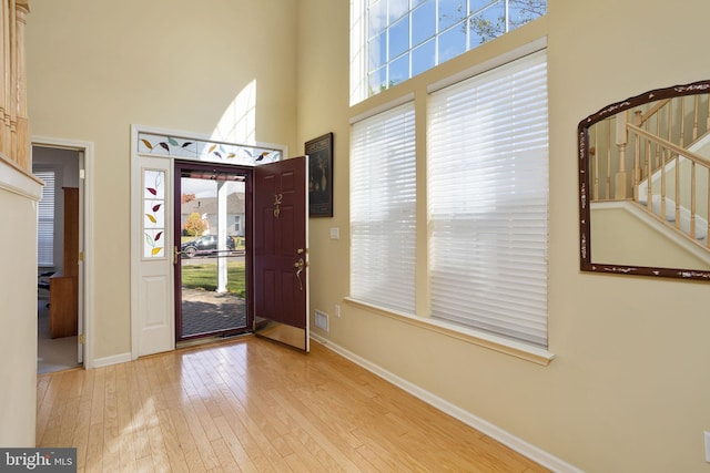 foyer featuring light hardwood / wood-style flooring and a high ceiling