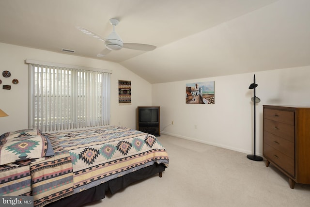 carpeted bedroom with vaulted ceiling and ceiling fan