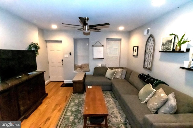 living room with ceiling fan and light hardwood / wood-style flooring