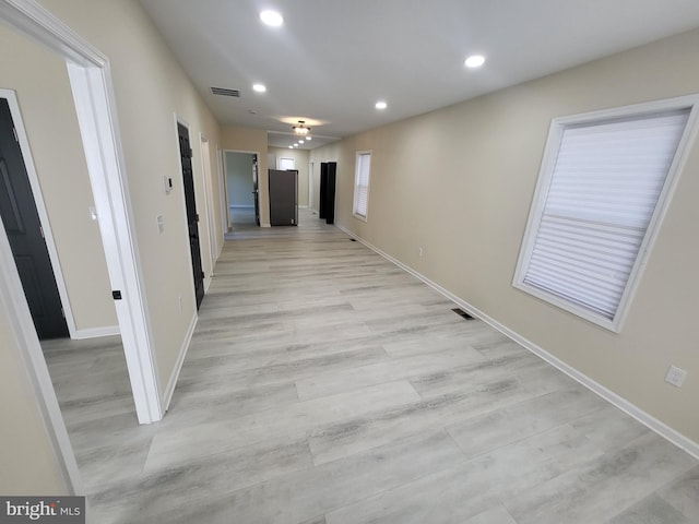 corridor with light hardwood / wood-style flooring