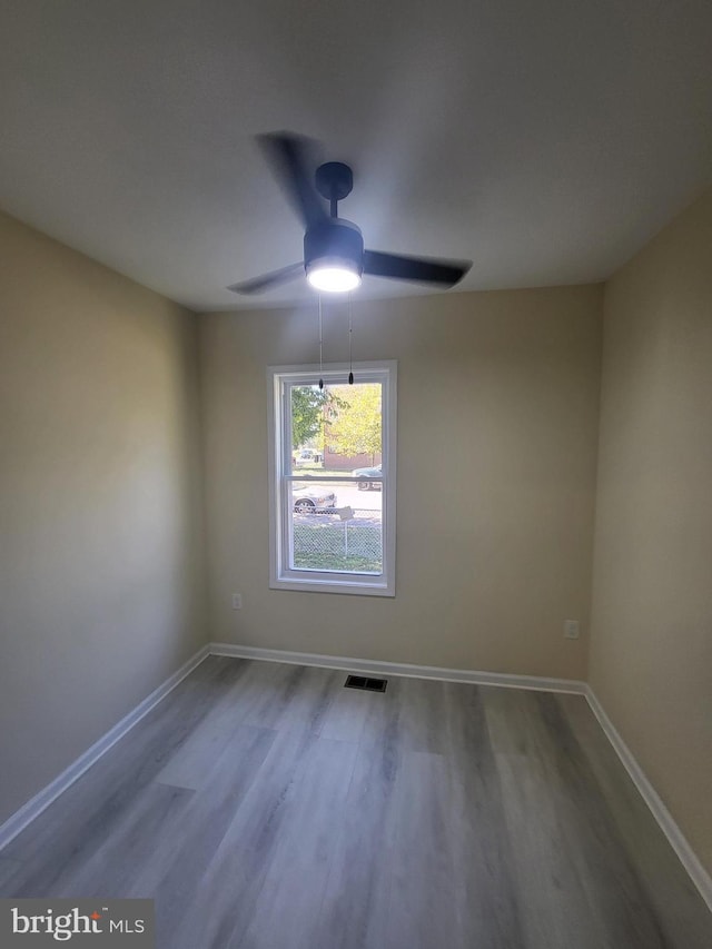 empty room featuring ceiling fan and wood-type flooring