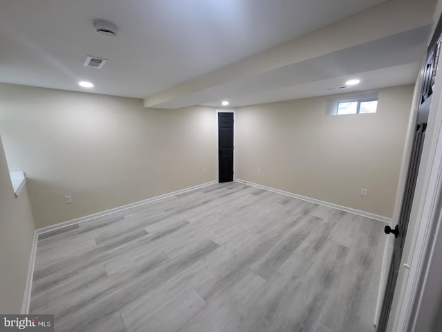 basement with light hardwood / wood-style floors