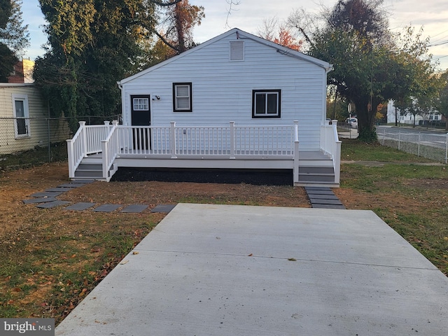 back of property featuring a yard and a deck