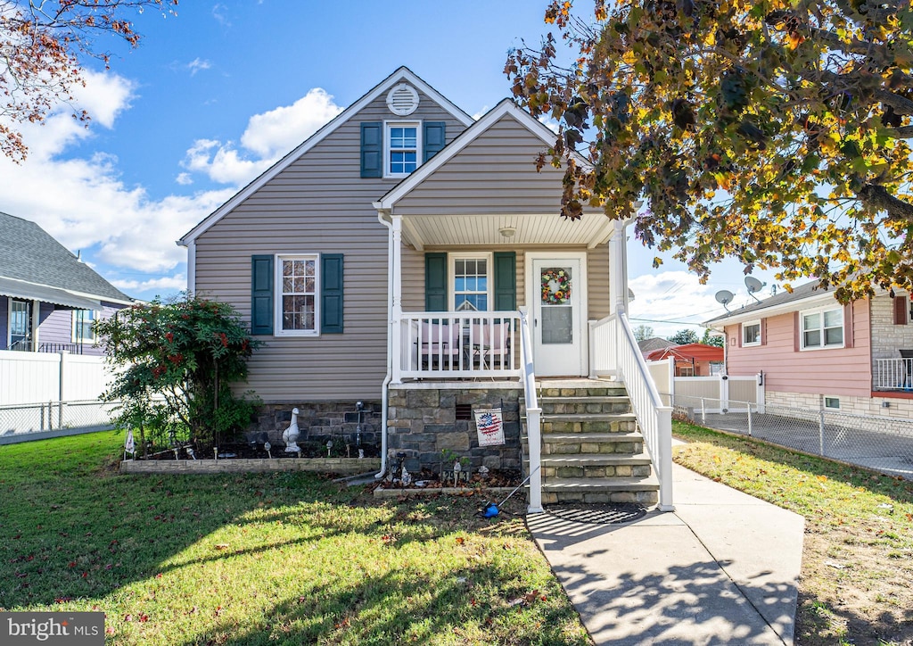 bungalow-style house with a front lawn and covered porch