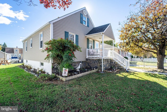 view of side of home featuring a yard and a porch