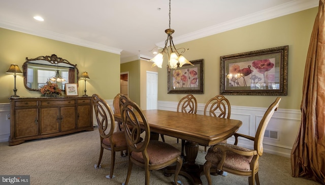 dining room with light carpet, crown molding, and an inviting chandelier