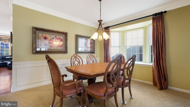 dining area with a chandelier and ornamental molding