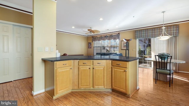 kitchen with ceiling fan, light hardwood / wood-style flooring, crown molding, and decorative light fixtures