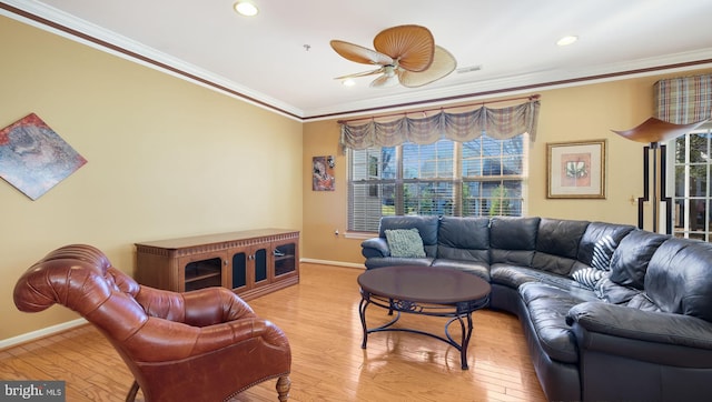 living room with light hardwood / wood-style flooring, ceiling fan, and crown molding