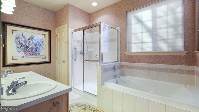 bathroom featuring vanity and shower with separate bathtub