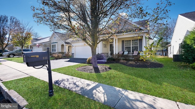 view of front of house featuring a garage, a front lawn, and a porch